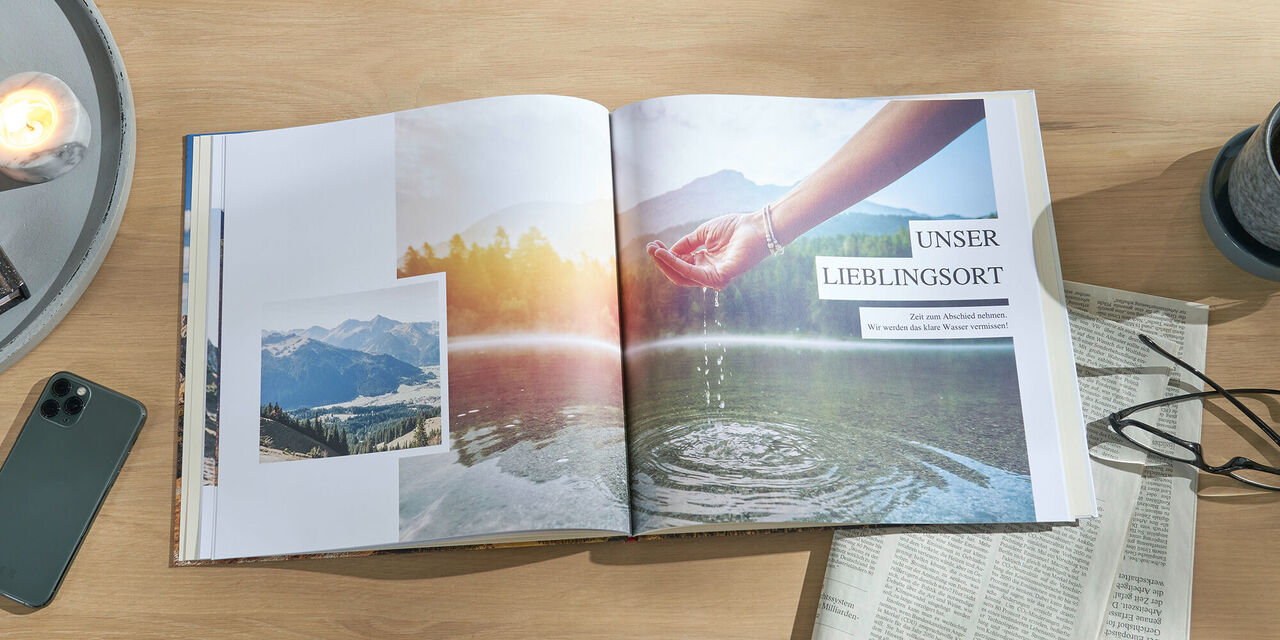 Ein offenes Fotobuch zeigt schöne Erinnerungen an Erlebnisse in der Natur mit einem Bild einer Hand, die Wasser hält und Farb- und Fotokollagen.