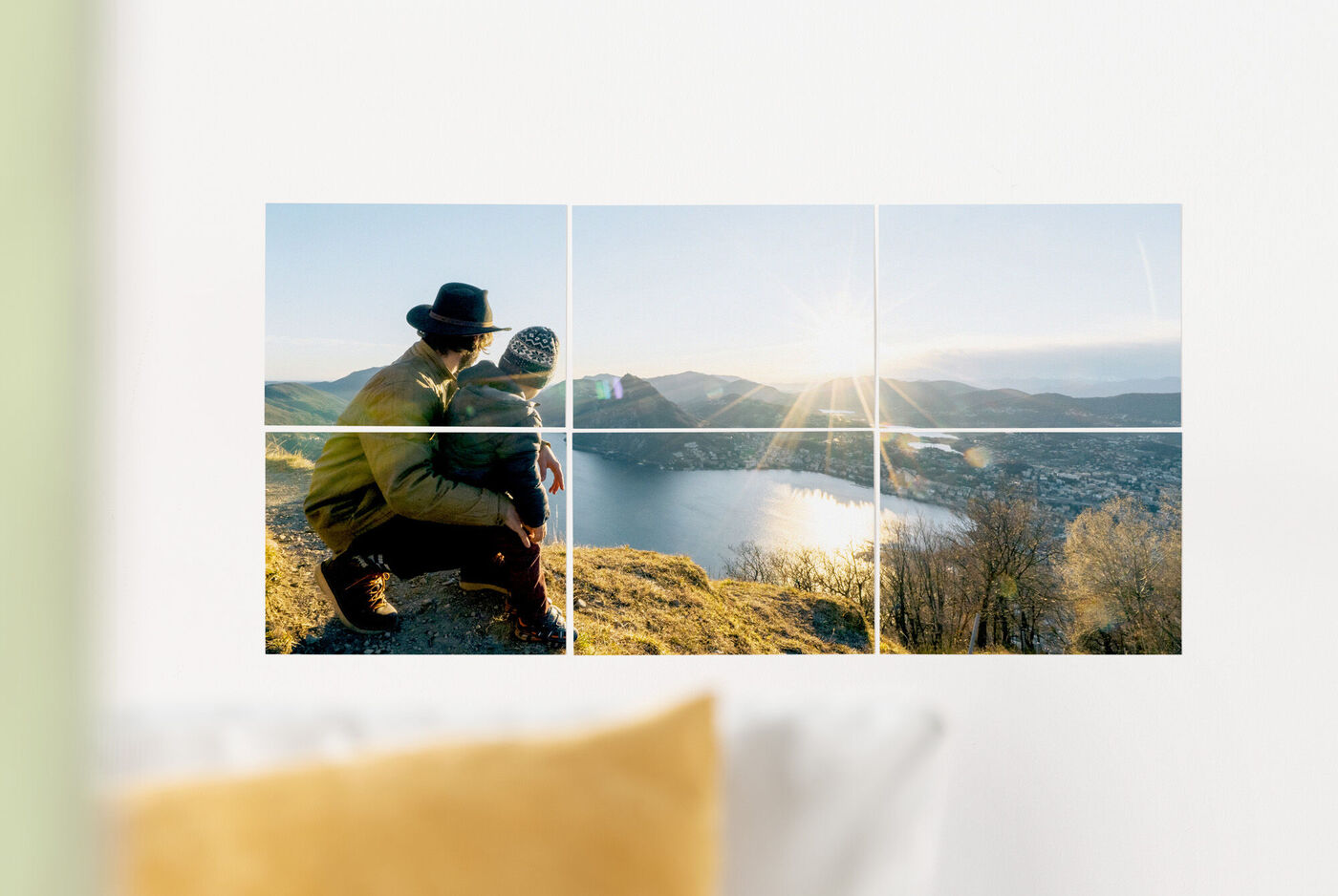 Zwei Personen sitzen auf einem Berg und genießen den Blick auf einen See bei Sonnenuntergang