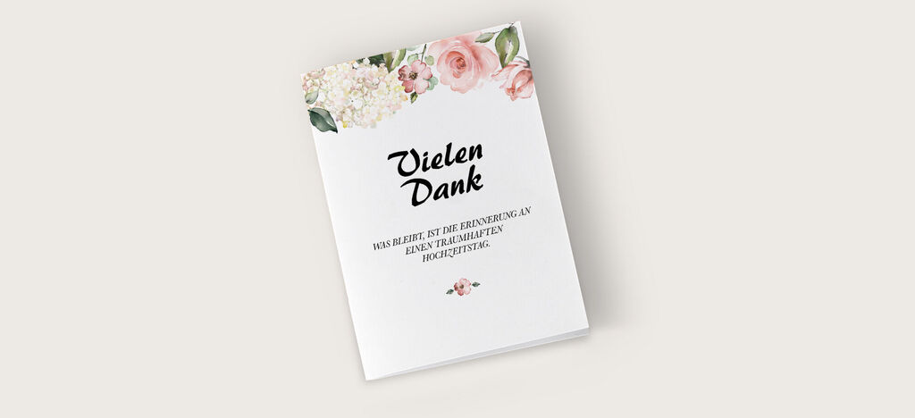 Eine elegante Dankeskarte mit floralen Verzierungen und dem Text "Vielen Dank".