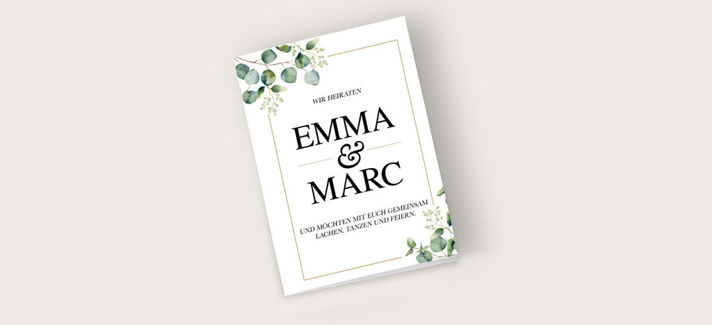 Ein wunderschön gestaltetes Hochzeitskarten-Design mit dem Schriftzug „Emma & Marc“ auf hellem Hintergrund und grünen Blättern.