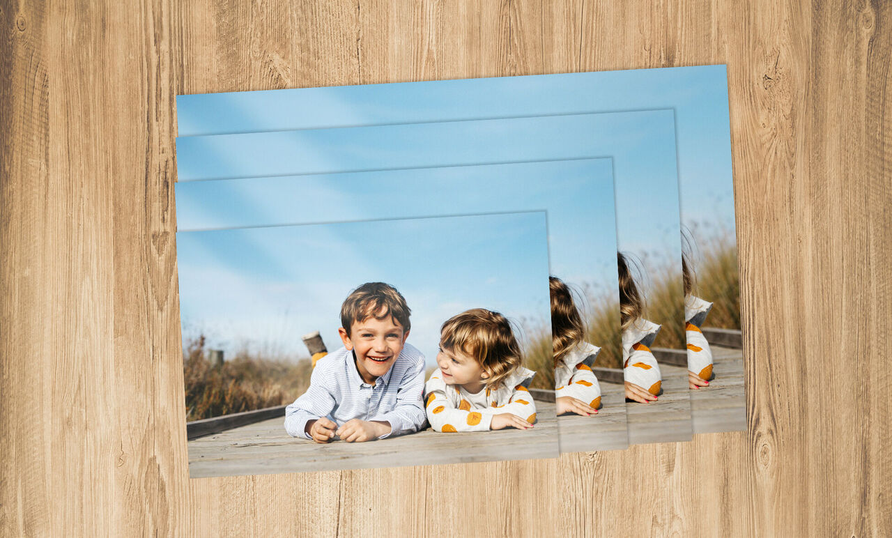Zwei Kinder liegen entspannt auf einem Holzsteg und genießen einen sonnigen Tag.