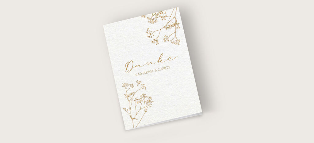 Eine elegante Dankeskarte mit der Aufschrift 'Danke', verziert mit zarten goldenen Blütenmotiven.
