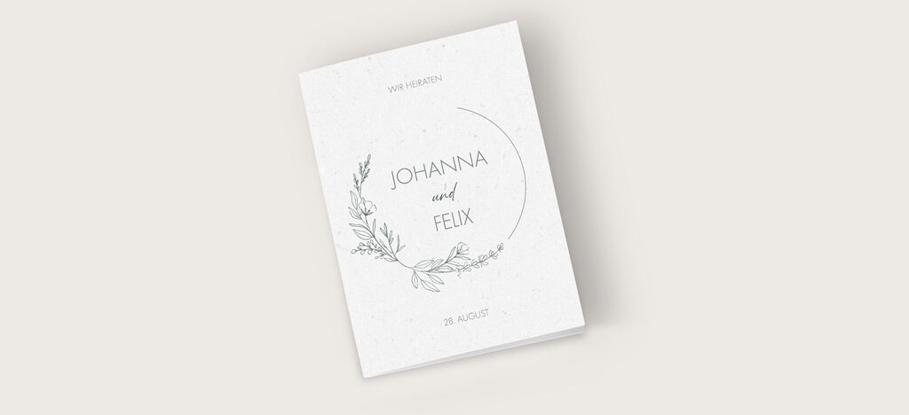 Ein schönes, schlichtes Gästebuch für eine Hochzeit mit einer floralen Umrandung und den Namen Johanna und Felix auf dem Cover.