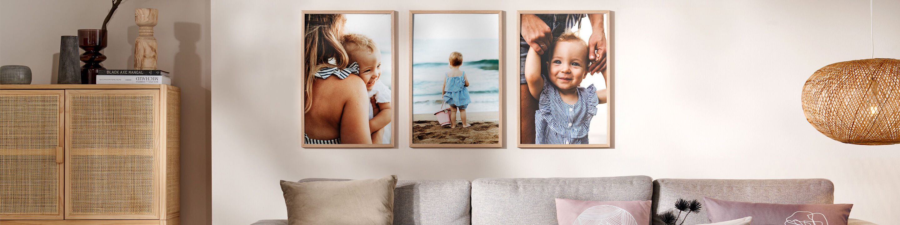 Drei Bilder von Familienmomenten an einem Strand, rahmenverzierte Fotografie an einer Wand.